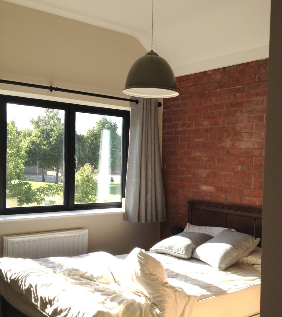 bedroom with exposed brick wall